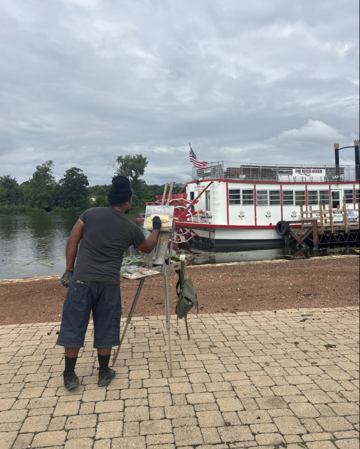Visitors browsing outdoor art displays and murals during the Downtown Art Walk