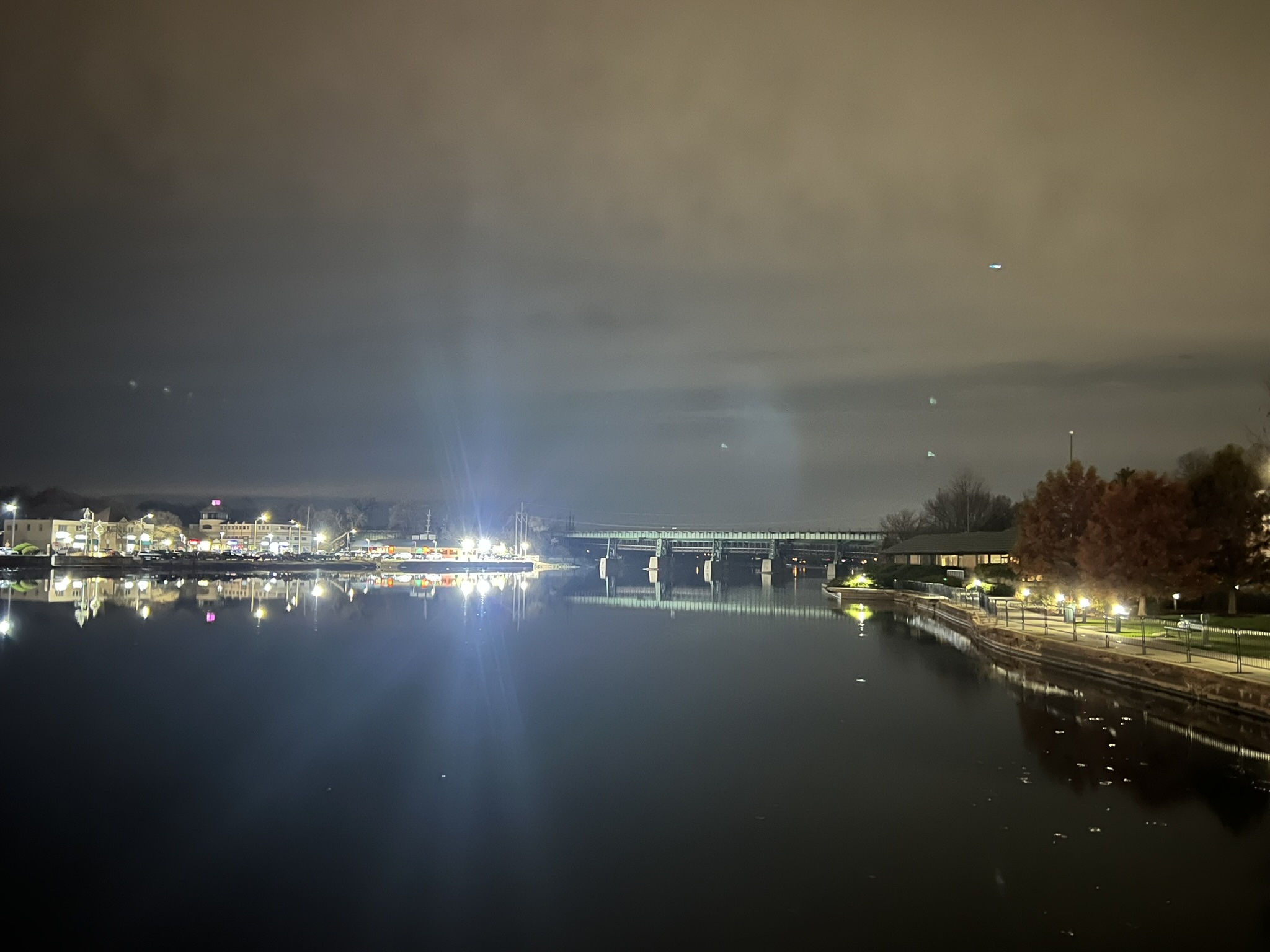 Evening lights along the St. Charles riverwalk reflecting on the Fox River.